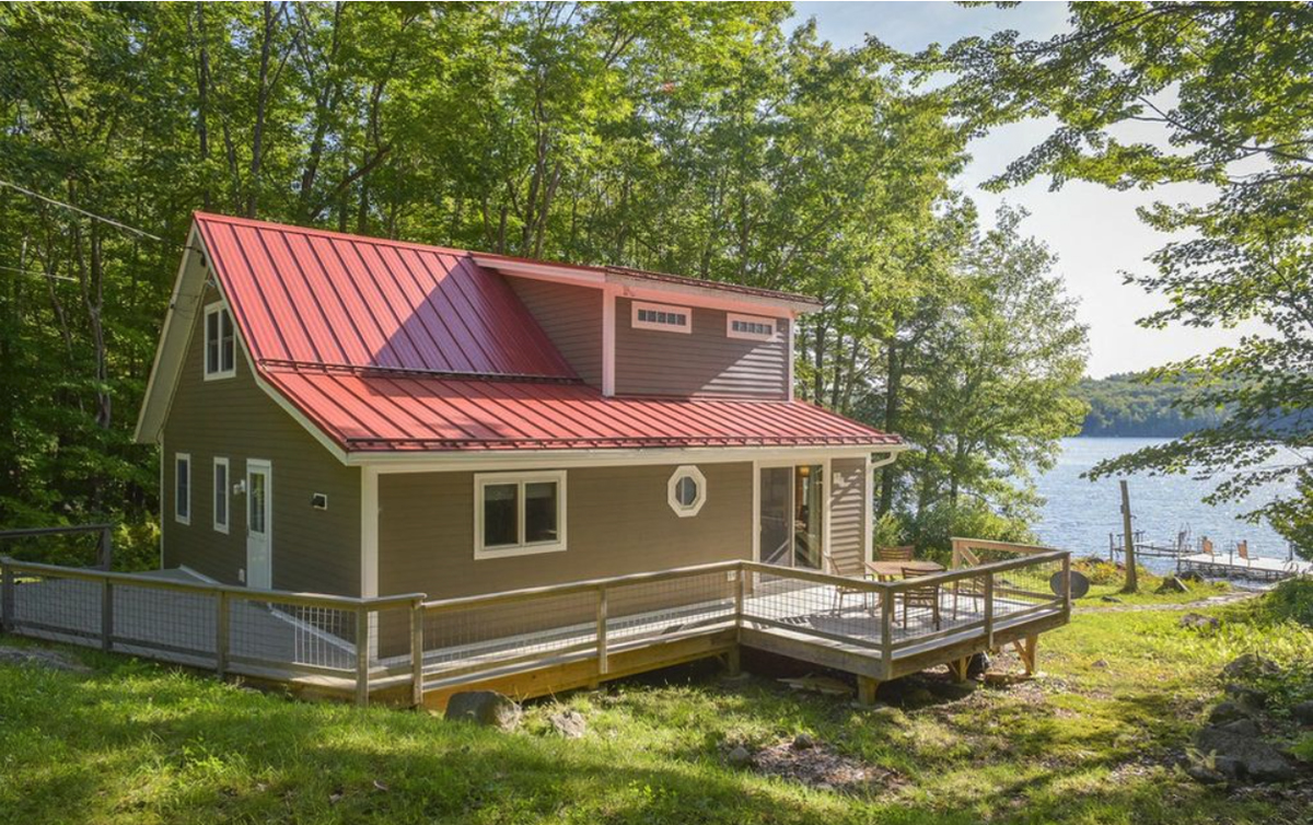 Beige house with red roof and white trim
