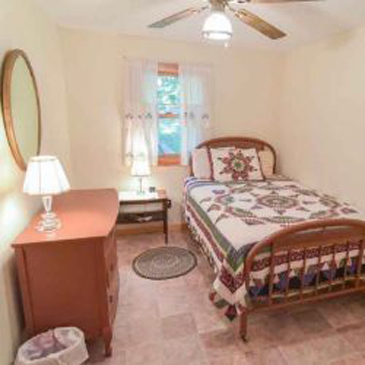 Fourth bedroom with full size bed to the right, dresser to left