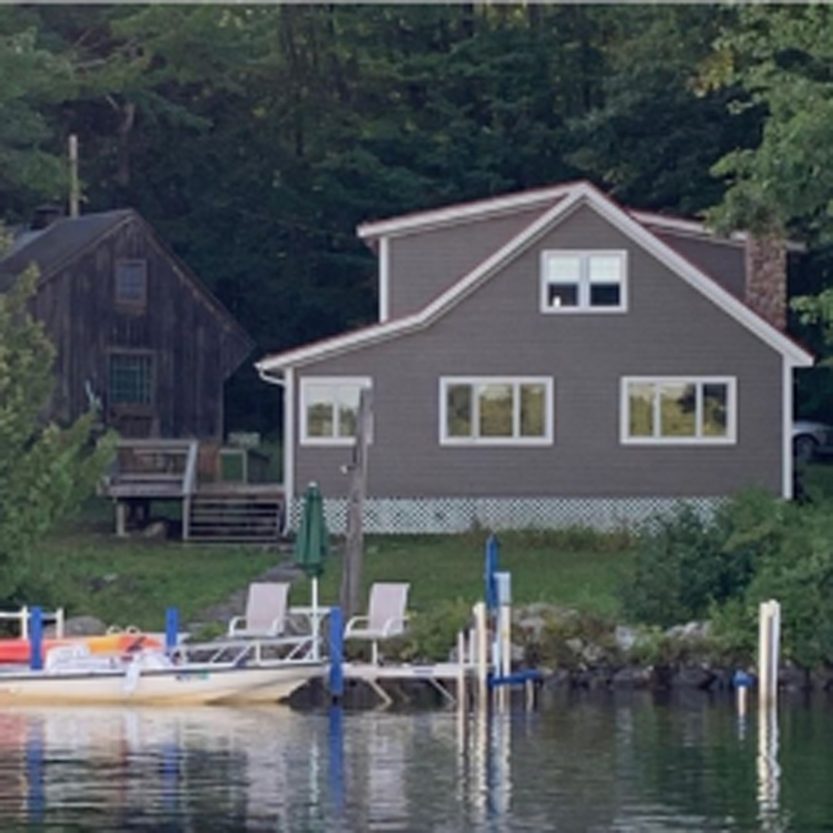 Paddle boat, dock with beige house in background