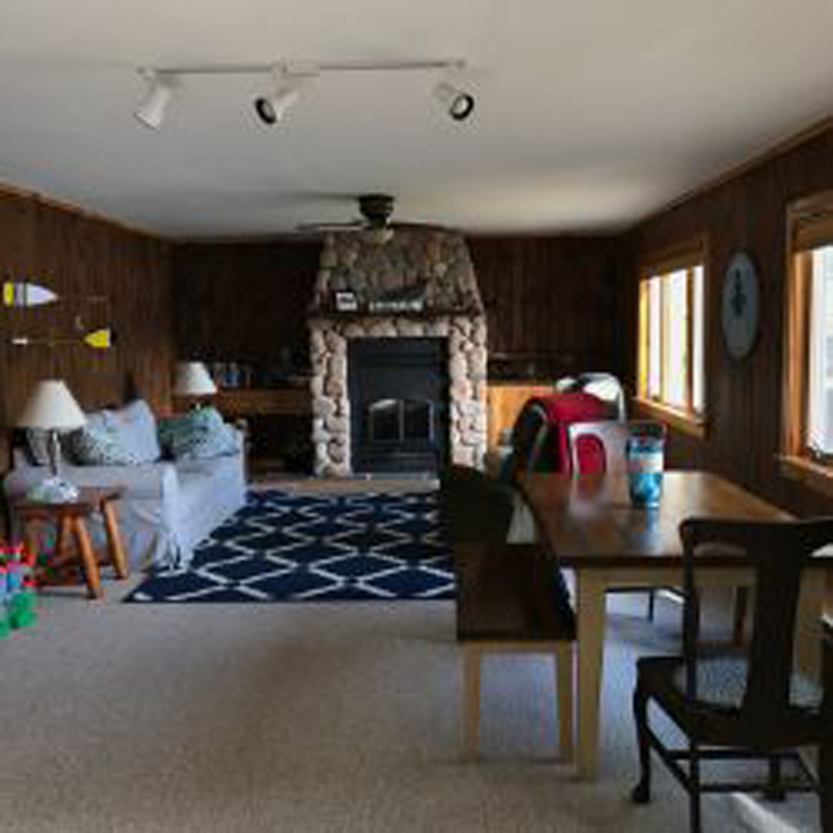 Living Room with sofa, fireplace and dining table