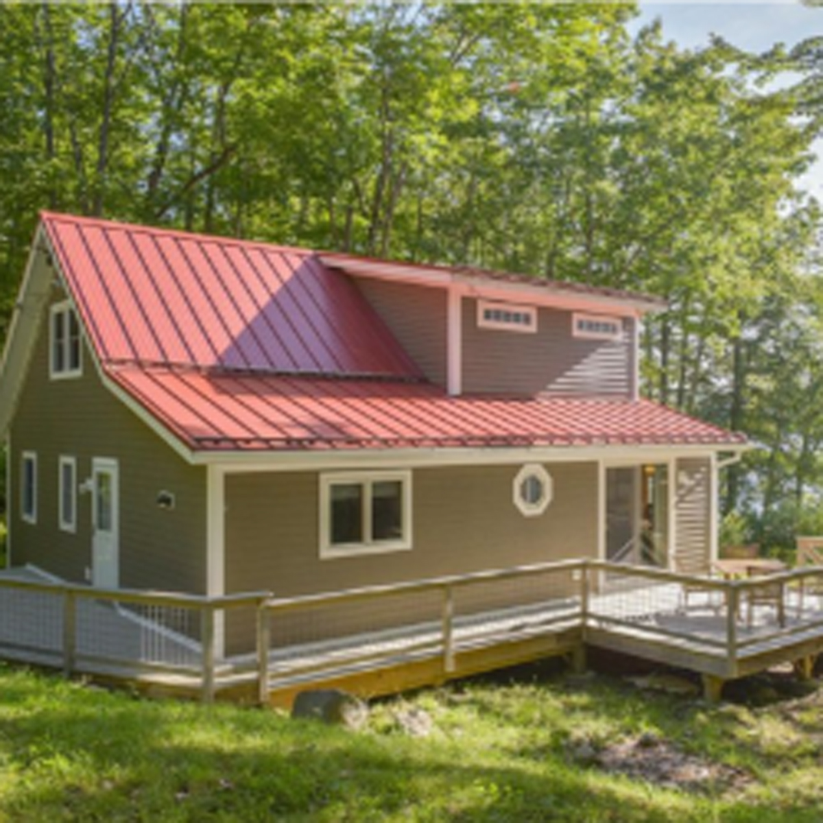 Sunny outdoor shot of whole house looking at side deck